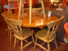 A honey oak extending dining table with