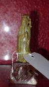 A Chinese soapstone figurine on wooden s