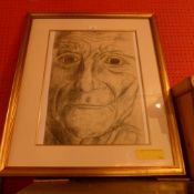 A glazed and framed pencil portrait of a