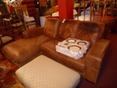 A tan leather corner sofa raised on bloc