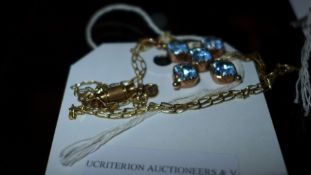 A 9ct gold chain with blue stone inset p