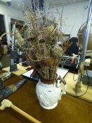 Water Jug Containing Artificial Flowers