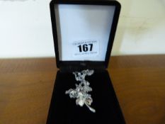 Ladies Silver Coloured Pendant of a Flower with a Green Stone