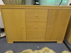 Sideboard Unit with Drawers Enclosed by Double Doors in Light Wood Finish
