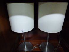 *Pair of Brushed Stainless Steel Lamps with Cream Shades