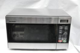 1 x Sharp 22 Liter Stainless Steel Microwave - Model R299T - Taken From An Office Environment,  In