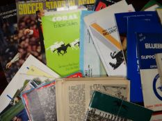 A quantity of sports programmes, F.L. Reviews, sticker albums, five football and cricket