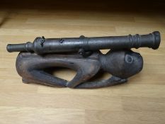 A brass Lantaka cannon on South East Asian carved monkey mount, (61 cms) in length