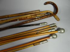 A bundle of swagger sticks and canes, some Royal Army Medical Corps and hallmarked silver-tipped