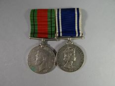 A WWII Defence Medal and Police Exemplary Service Medal to Sergt. Albert J. Day mounted as worn