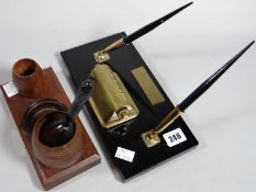 Two pen and ink desk adornments to include one made from the timber of H.M.S. Worcester, the other