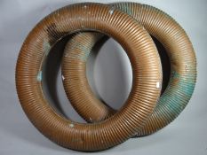 A pair of antique ribbed copper lifebelts, 29 ins (74 cms) diameter