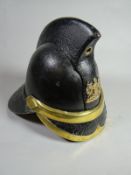 A Victorian black leather and brass fireman's helmet with Cardiff City coast of arms