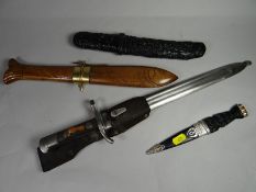 A Finnish M27 bayonet with scabbard, frog and blade marked 'Hackman & Co.' together with two