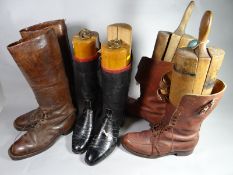Three pairs of leather military boots, two with wooden lasts