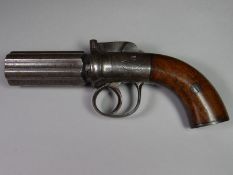 A nineteenth century six-shot pepper box pistol with polished wooden grip and decorative foliate