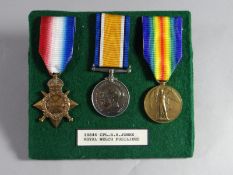 A WWI 1914-15 trio of medals to 14844 Cpl. R.R. Jones, R.W.F. pin-mounted onto green felt