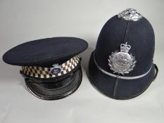 A Glamorgan Police helmet together with Dyfed Powys Constabulary Chief Inspector's peaked cap