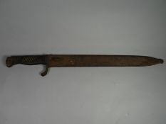An Imperial German Mauser bayonet in its scabbard with a blade marked Deutsche Maschinenfabrik A.