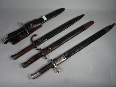 Four bayonets of the world with scabbards