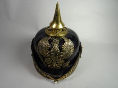 A German Officer's pickelhaube with chin scales and State cockades and leather bordered lining
