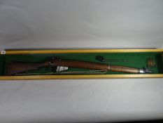 A framed WWI 303 Lee Enfield bolt-action rifle with spike bayonet and spare round mounted in a