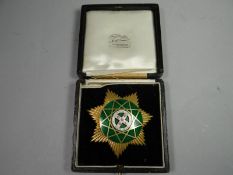 A hallmarked silver gilt and enamel badge in Toye & Co. Masonic outfitters box of issue