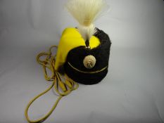 A Hussars busby with yellow felt bag and cord lines with horsehair plumage, brass fittings and