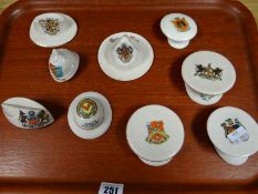 Nine crested china hats and helmets