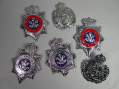 Six assorted police helmet plates