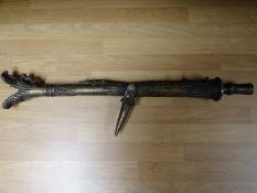 A reproduction brass cannon with the barrel head shaped into dragons teeth, (71 cms) in length