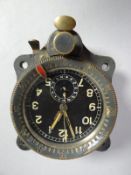 A German WWII Me109 clock marked on metal tab 'Bordhur Shwartz. Gebr. Junghans' with serial nos.