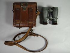A pair of German binoculars marked 'Dienstglas' in leather case with strap and Instructions for