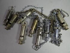 Nine assorted police whistles, some with chains and hooks