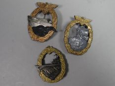 A Kriegsmarine Destroyer Breast Badge together with a Kriegsmarine Auxiliary Cruiser Breast Badge