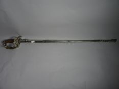 A Siamese sword with elephant's head pommel, metal scabbard, knot and finely-etched blade marked '