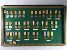 A framed collection of Royal Welsh Fusiliers WWI medals consisting of ten British War Medals, ten