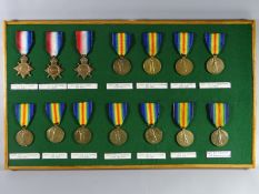 A framed collection of WWI Medals consisting of eleven Victory Medals and three 1914-15 Star