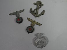 A German Reunification 1935 Seafaring Day Badge together with two Kriegsmarine cap badges and a