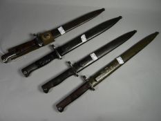 Four bayonets of the world all with scabbards, including one with Siamese marked blade