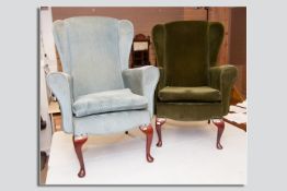 Two 20th Century upholstered wingback armchairs