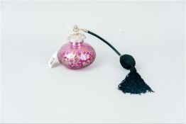 A pink and gilt art glass onion shaped cologne bottle with scrolled and figural silver top, 10 grms,