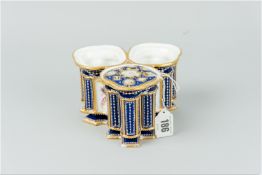 A triple cobalt and gilt decorated vase having heavily jewelled and gilt decorated columns and