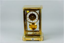 An impressive brass mantel clock probably of French manufacture, the case with twin opening doors