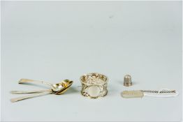 A silver oblong 'Gin' label with chain, 0.25 ozs, London 1936, a silver thimble and three odd silver