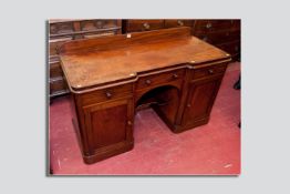 A Victorian mahogany twin pedestal desk, shaped top with rail back over three drawers with turned