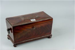 A good quality Georgian mahogany tea caddy, the segmented top having a bead carved centre panel,