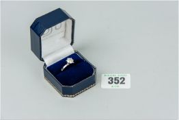 A lady's fourteen carat white gold diamond solitaire ring having a round cut solitaire diamond, 1.