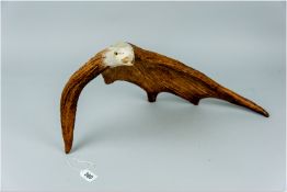 An excellently carved possibly elk antler in the form of an open mouthed eagle with a good