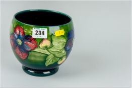 A Moorcroft 'Clematis' globular shaped vase, green ground body surrounded with tube lined pattern,